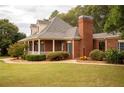 Side view of brick home showcasing the porch and landscaping at 75 Rivercreek Xing, Kingston, GA 30145