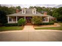 Grand brick home with a covered porch and manicured landscaping at 75 Rivercreek Xing, Kingston, GA 30145