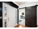 Front entry with barn door and hardwood floors at 928 Buckhorn Bnd, Locust Grove, GA 30248