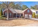 Brick home with 2-car garage and landscaped yard at 928 Buckhorn Bnd, Locust Grove, GA 30248