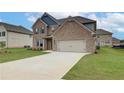 Two-story brick home with a large front yard and driveway at 115 Felicity Pike, Locust Grove, GA 30248