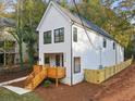 Modern farmhouse with a large backyard and wood fence at 2438 2Nd Nw St, Atlanta, GA 30318