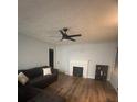 Living room with hardwood floors, fireplace, and ceiling fan at 3006 Dogwood Dr, Hapeville, GA 30354