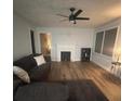 Living room with hardwood floors, fireplace, and ceiling fan at 3006 Dogwood Dr, Hapeville, GA 30354