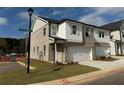 Two-story townhome with brick and siding, two-car garage, and landscaping at 328 Shine Dr, Stockbridge, GA 30281