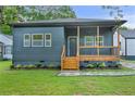 Inviting home featuring new siding, a wooden porch, and manicured landscaping at 639 Ozburn, Atlanta, GA 30318