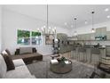 A bright, open-concept living space features a sleek kitchen with counter seating and comfortable modern furnishings at 639 Ozburn, Atlanta, GA 30318