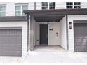 Townhome's front entrance with gray door and covered porch at 2920 Ilir Nw Mnr, Atlanta, GA 30318