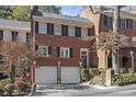 Front view of townhome showcasing brick facade and attached garage at 105 Jefferson Ne Cir, Atlanta, GA 30328