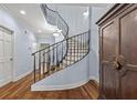 Grand curved staircase with wrought iron railing, elegant entryway at 105 Jefferson Ne Cir, Atlanta, GA 30328