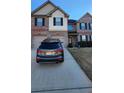 Two-story house with gray and white brick exterior, two-car garage, and driveway at 416 Culloden Moor Dr, Mcdonough, GA 30253