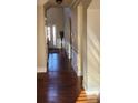 Hardwood floor hallway with wainscoting and view into entryway at 416 Culloden Moor Dr, Mcdonough, GA 30253