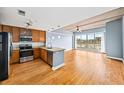 Kitchen with wood cabinetry, stainless steel appliances, and views from the large window at 563 Memorial Se Dr # 405, Atlanta, GA 30312