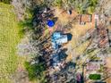 An aerial view showcasing a house, pool, and additional structures on a spacious lot at 12524 Highway 36, Covington, GA 30014