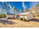 Exterior view of a single-story house with a neat lawn and landscaping at 12524 Highway 36, Covington, GA 30014