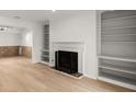 Spacious living room with a fireplace, built-in bookshelves, and light hardwood flooring at 2042 Brian Way, Decatur, GA 30033