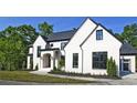 White brick home with black windows and a two-car garage at 2346 East Maddox Rd, Buford, GA 30518