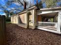 Side view of a yellow house needing renovation, with a porch and yard at 309 Holderness Sw St, Atlanta, GA 30310