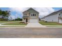 Two-story home with light brick and siding, two-car garage, and driveway at 75 Barge Ln, Covington, GA 30016