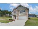 Two-story brick home with a two-car garage and a landscaped yard at 75 Barge Ln, Covington, GA 30016