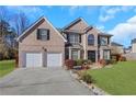 Brick two-story house with a two-car garage and landscaped lawn at 1943 Ivy Branch Ct, Loganville, GA 30052