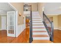 Elegant staircase with wrought iron railing and hardwood floors at 1943 Ivy Branch Ct, Loganville, GA 30052