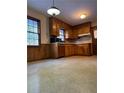 Retro kitchen with wood cabinets and laminate floors at 3265 Heard Drive, Cumming, GA 30040