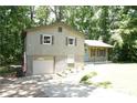 Ranch home with attached garage, blue door, and landscaped yard at 34 Timber Chase Dr, Dallas, GA 30157