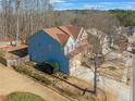 Two-story house with blue siding, red accents, and a large backyard at 753 Win West Xing, Auburn, GA 30011