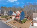 Two-story house with blue siding and red accents situated in a residential neighborhood at 753 Win West Xing, Auburn, GA 30011