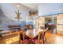 Spacious dining room with a large table, hardwood floors, and stone accent wall at 753 Win West Xing, Auburn, GA 30011