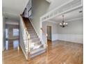 Elegant staircase with hardwood floors and white railing at 2714 Legislative Ln, Buford, GA 30519