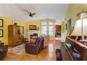 Bright living room with a fireplace, wood floors, and large windows at 3529 Flowering Spgs, Powder Springs, GA 30127