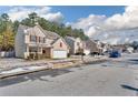 Houses on a tree-lined street with light snow on the ground at 7369 Saint Peter Way, Fairburn, GA 30213