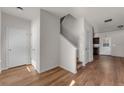 Open foyer with hardwood floors leading to the staircase and other rooms at 7369 Saint Peter Way, Fairburn, GA 30213