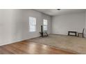 Spacious living room featuring hardwood floors and neutral walls at 7369 Saint Peter Way, Fairburn, GA 30213