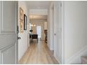 Light and bright entryway with hardwood floors, leading to the living and dining areas at 591 River Gardens Se Dr, Atlanta, GA 30354