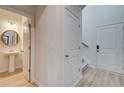 View of a second entry with powder room and stairs leading upstairs at 591 River Gardens Se Dr, Atlanta, GA 30354