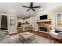 Spacious living room with a stone fireplace and hardwood floors at 2714 Vinings Oak Se Dr, Atlanta, GA 30339