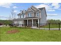 Two-story home with gray siding, brick accents, and a landscaped yard at 1617 Tide Mill Rd, Cumming, GA 30040