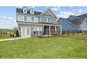 Two-story home with gray siding, brick accents, and a fenced yard at 1617 Tide Mill Rd, Cumming, GA 30040