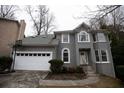 Gray two-story house with white garage door and landscaping at 500 Chimney House Ct, Stone Mountain, GA 30087