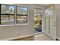 Renovated entryway with light walls, new flooring and door leading to backyard at 80 Yvette Ne Ct, Kennesaw, GA 30144