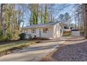 Newly renovated house with green door and driveway, surrounded by trees at 80 Yvette Ne Ct, Kennesaw, GA 30144