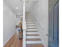 Inviting foyer with hardwood floors, a staircase, and neutral decor at 1688 Jackson Sq, Atlanta, GA 30318