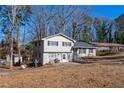 Two-story house with gray roof and white siding, nestled in a wooded area at 600 Green Mountain Trl, College Park, GA 30349