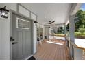 Modern front porch with gray door and wood flooring at 1841 Bayberry Dr, Atlanta, GA 30311