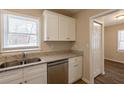 White cabinets, granite counters, and stainless steel appliances at 29 Oak Sw Dr, Atlanta, GA 30354