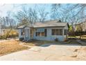 Gray bungalow with a spacious yard and driveway, offering curb appeal at 4471 Gibson Pl, Acworth, GA 30101