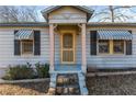 Inviting front door entrance with a yellow door and stone steps at 4471 Gibson Pl, Acworth, GA 30101